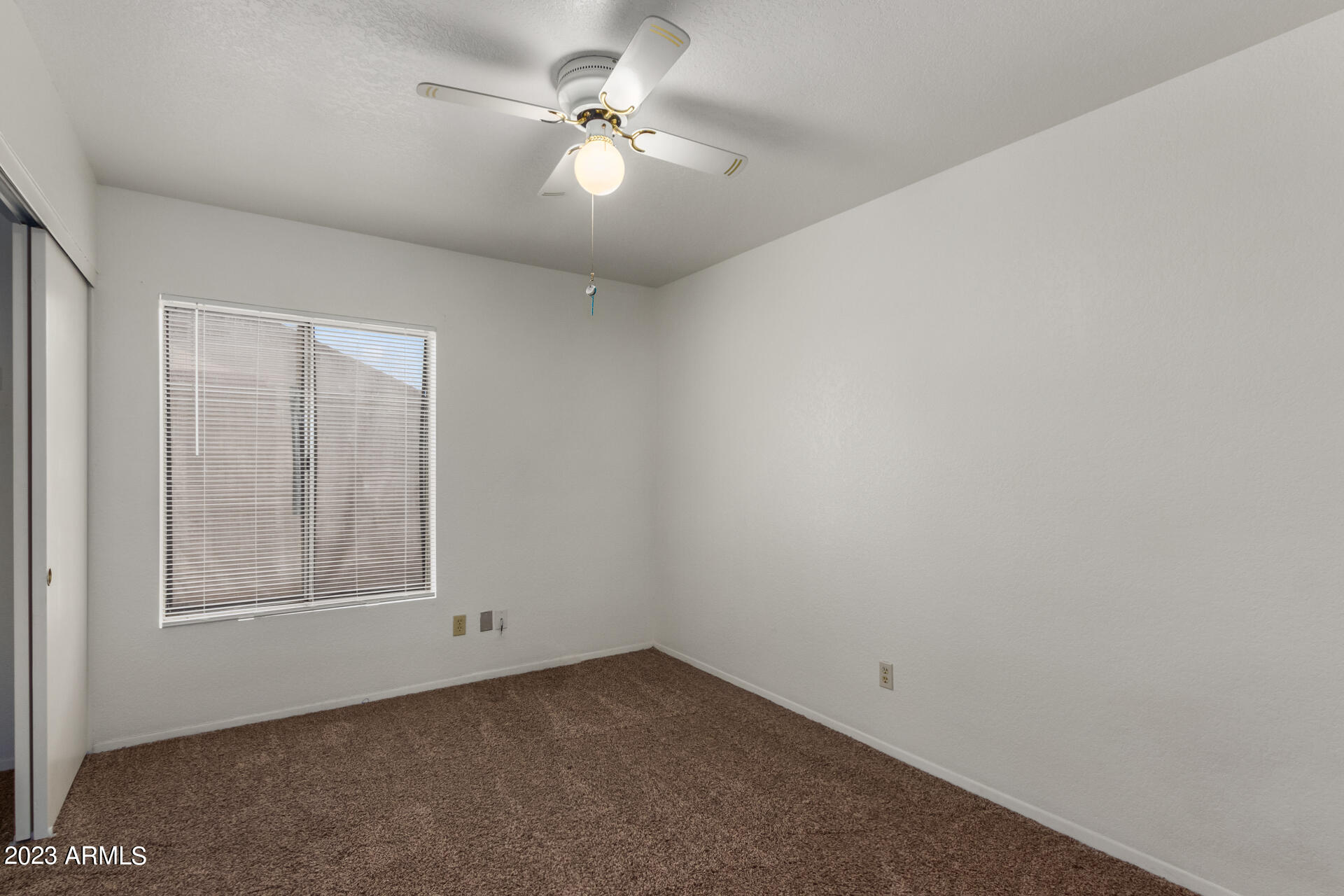 7331 West Paradise Drive Peoria, AZ 85345 - Photo 19 of 27 an empty room with windows and fan