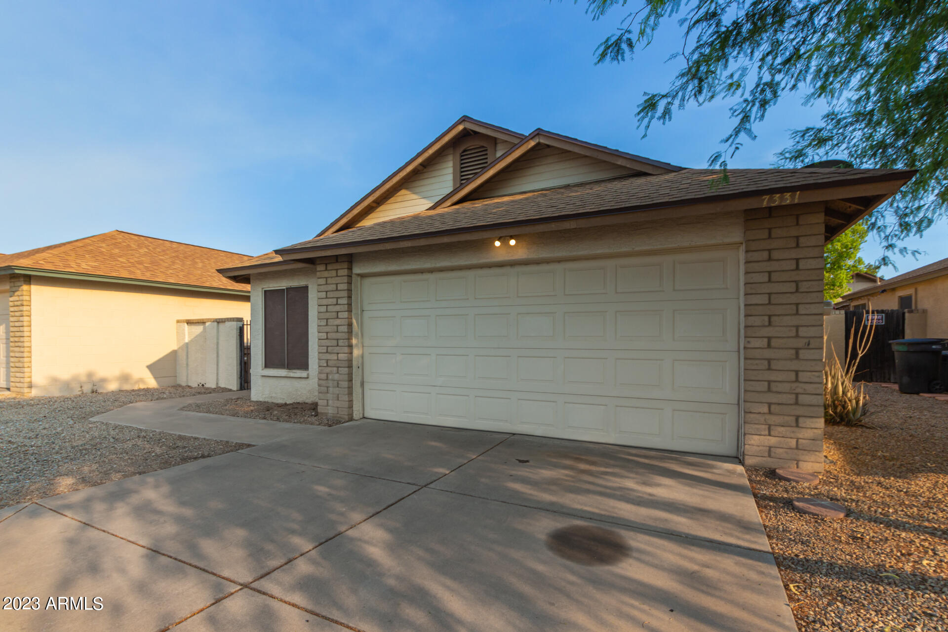 7331 West Paradise Drive Peoria, AZ 85345 - Photo 2 of 27 a front view of a house with a garage