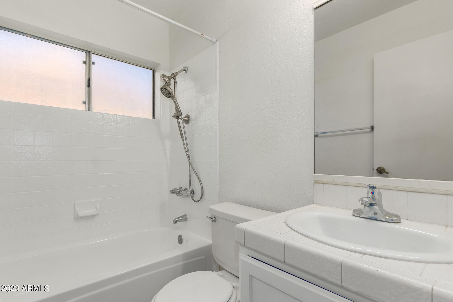 7331 West Paradise Drive Peoria, AZ 85345 - Photo 21 of 27 a bathroom with a sink toilet and shower