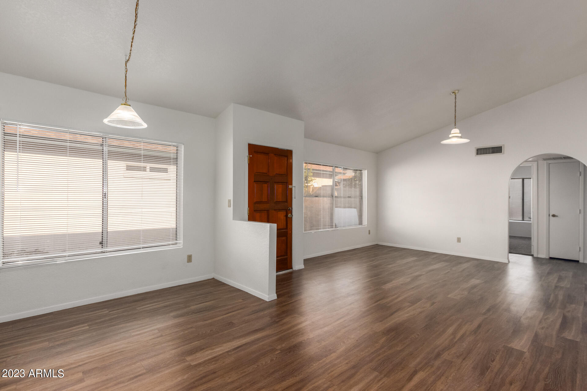 7331 West Paradise Drive Peoria, AZ 85345 - Photo 4 of 27 an empty room with wooden floor and windows