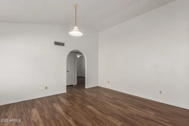 a view of a room with wooden floor and ceiling fan