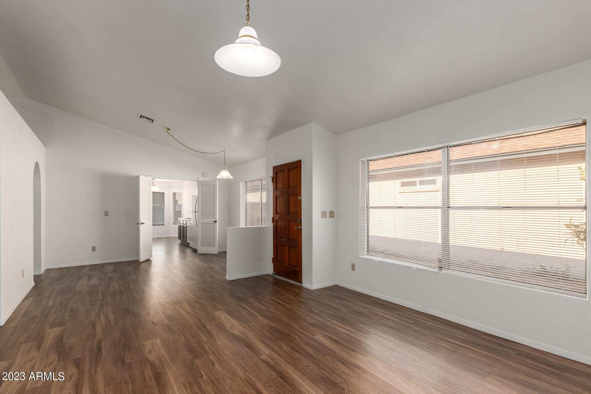 7331 West Paradise Drive Peoria, AZ 85345 - Photo 7 of 27 a view of empty room with wooden floor and window