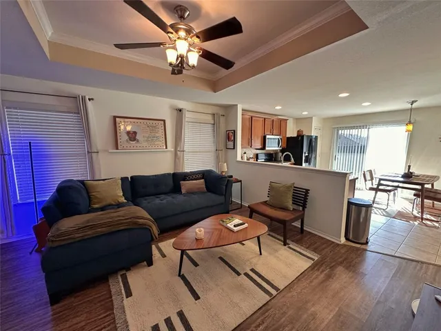 a living room with furniture and kitchen view