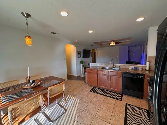 a kitchen with a sink stainless steel appliances and cabinets