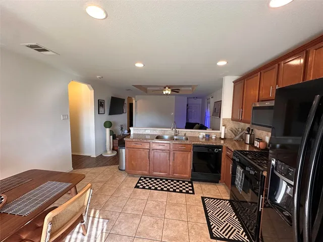 a kitchen with a sink appliances and cabinets
