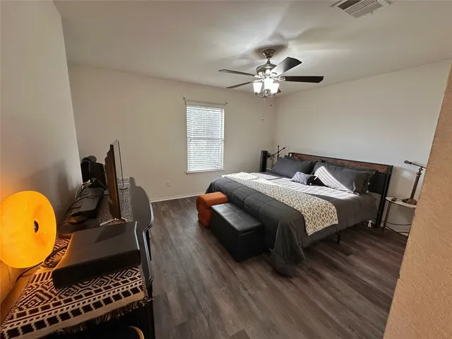 a bedroom with a bed dresser and a window