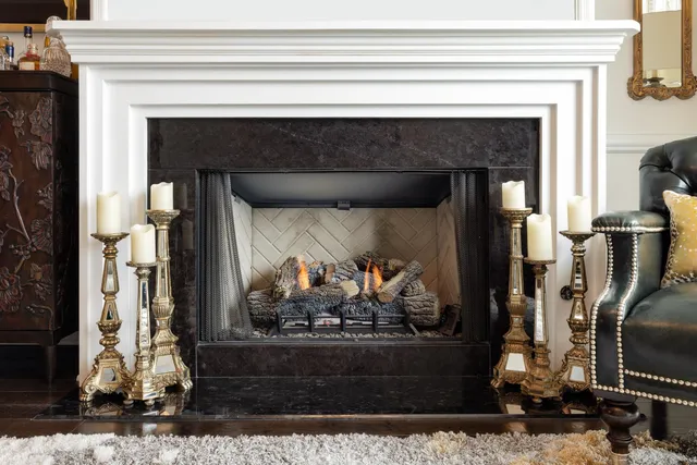 a living room with a fireplace and a fireplace