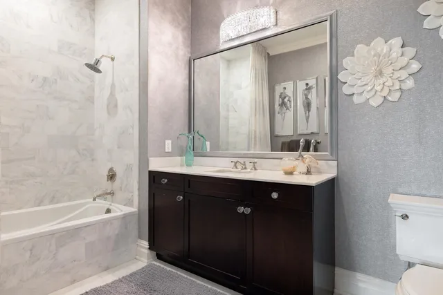 a bathroom with a tub sink and mirror