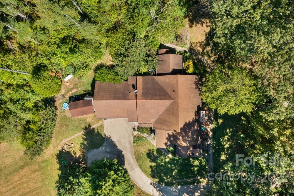 581 Flynn Road Rutherfordton, NC 28139 - Photo 14 of 37 an aerial view of a house with a yard and large trees