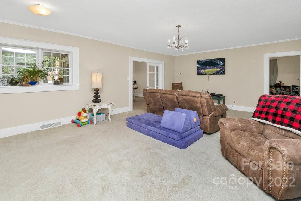 581 Flynn Road Rutherfordton, NC 28139 - Photo 20 of 37 a bedroom with furniture and a chandelier