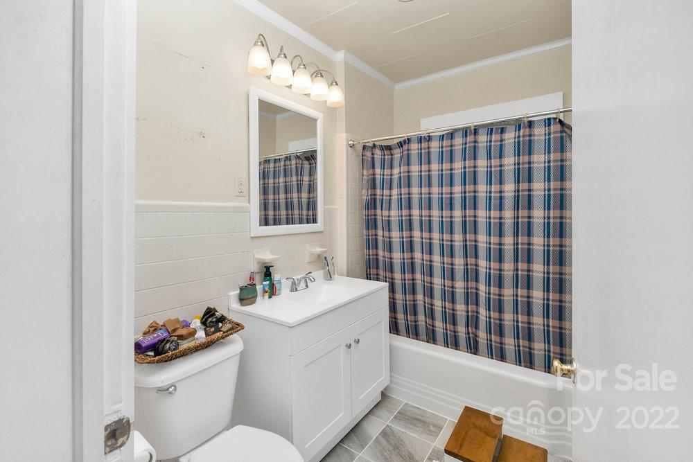581 Flynn Road Rutherfordton, NC 28139 - Photo 22 of 37 a bathroom with a sink mirror vanity and toilet