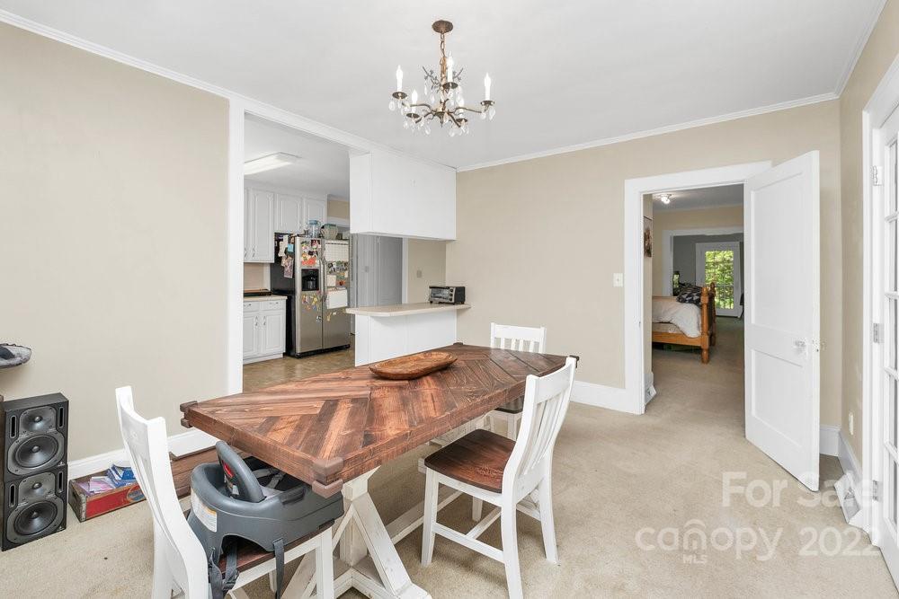 581 Flynn Road Rutherfordton, NC 28139 - Photo 28 of 37 a view of a dining room with furniture and chandelier