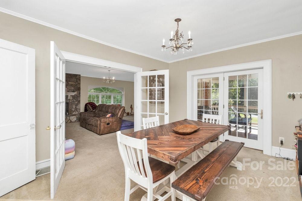 581 Flynn Road Rutherfordton, NC 28139 - Photo 29 of 37 a view of a dining room with furniture wooden floor and chandelier