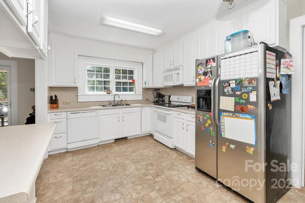 581 Flynn Road Rutherfordton, NC 28139 - Photo 32 of 37 a kitchen with stainless steel appliances a refrigerator sink and cabinets