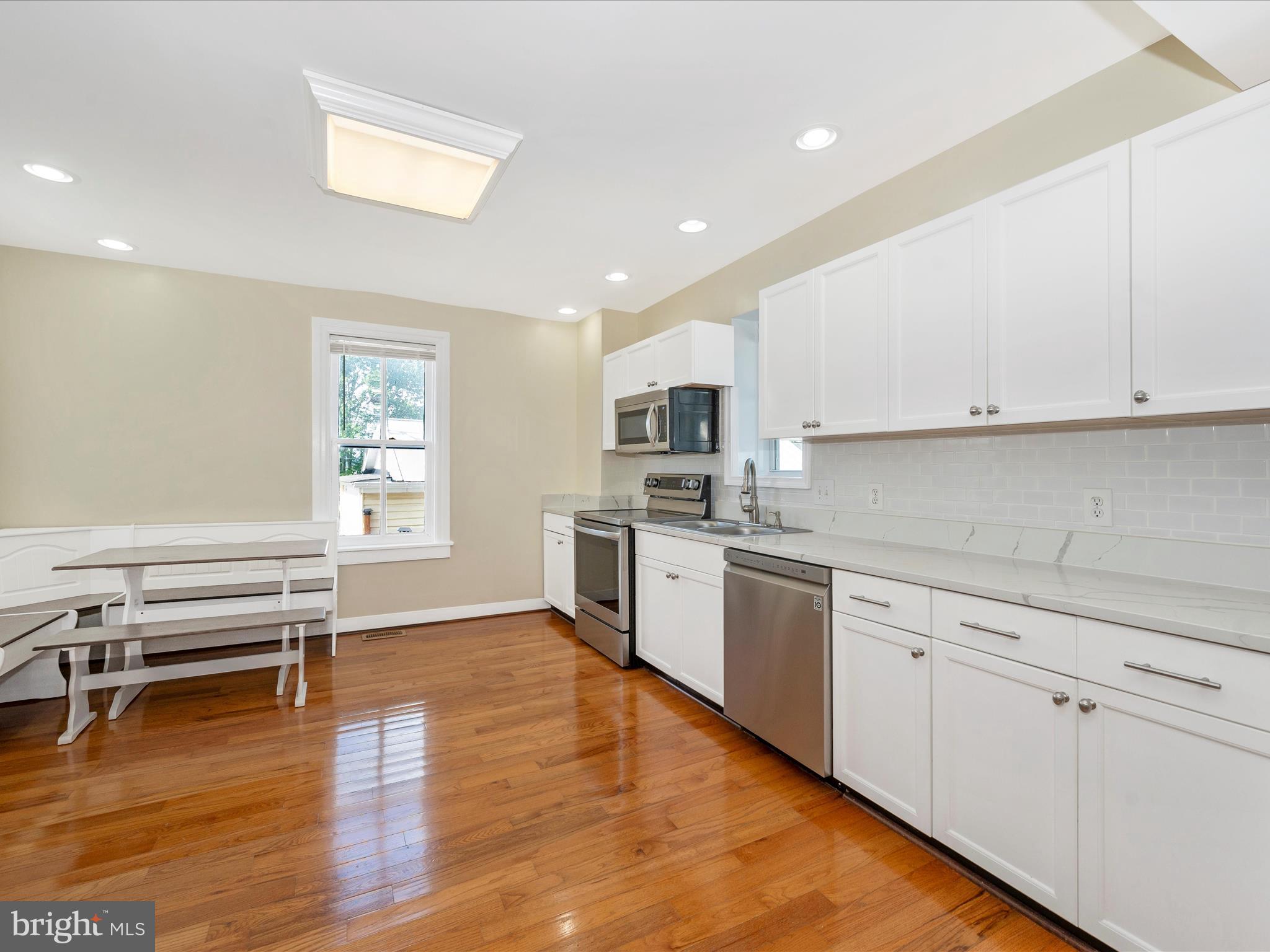 5924 Broad Run Road Jefferson, MD 21755 - Photo 16 of 54 a kitchen with stainless steel appliances granite countertop a stove and white cabinets
