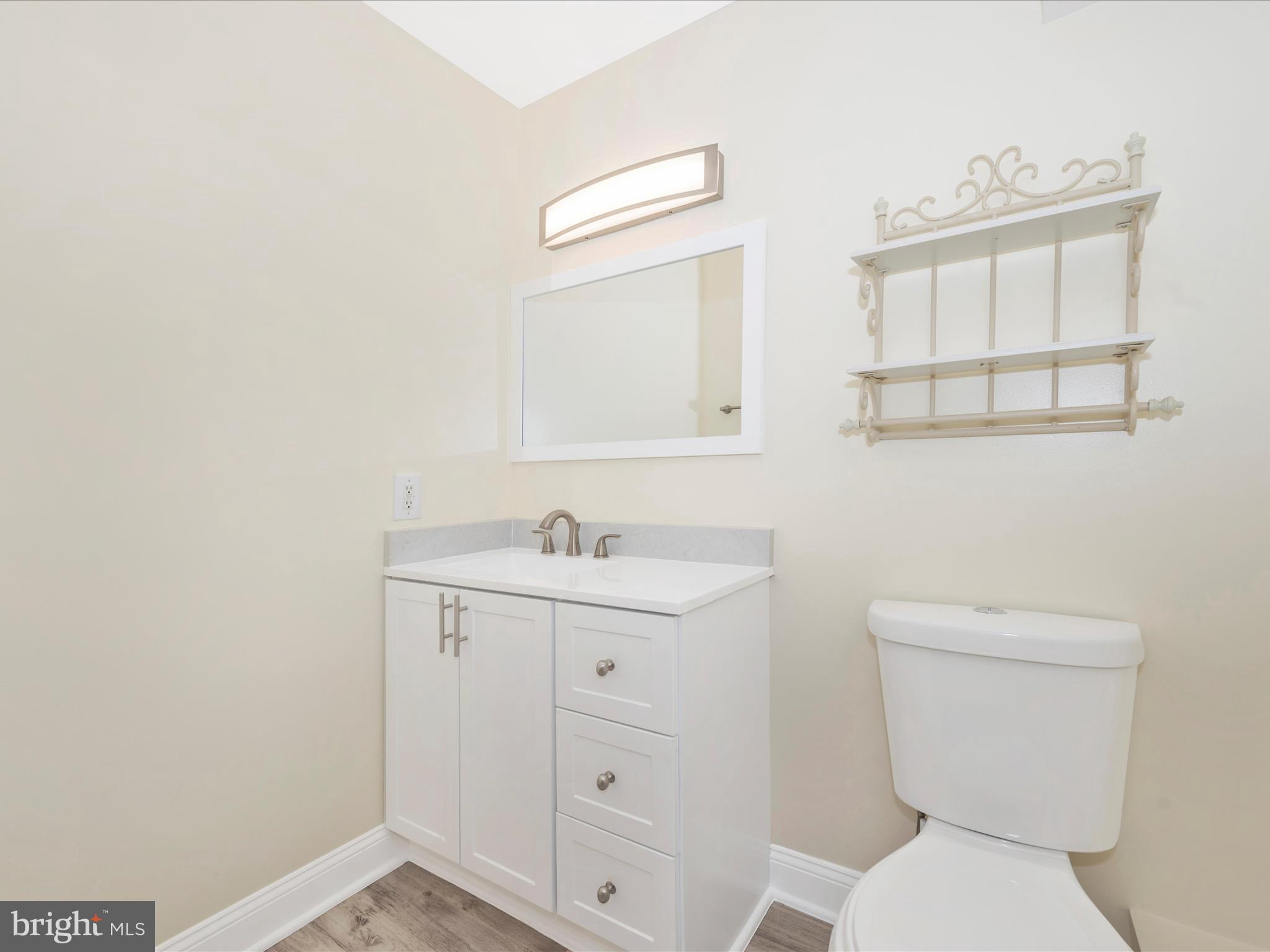 5924 Broad Run Road Jefferson, MD 21755 - Photo 29 of 54 a bathroom with a toilet a sink a vanity and mirror