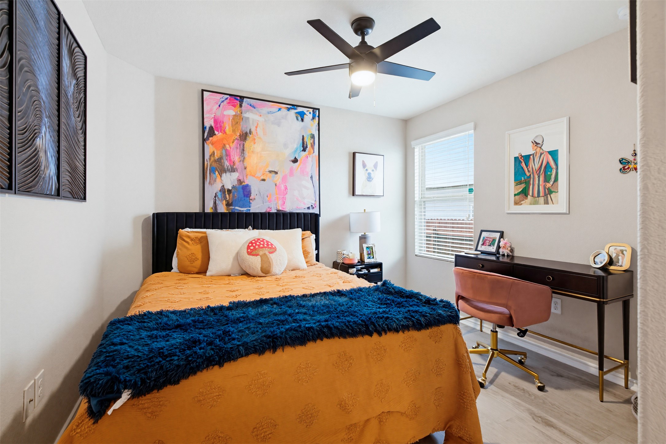 5705 Southerner Way Austin, TX 78747 - Photo 15 of 22 Relax in this tranquil room, featuring wood-look flooring and a modern ceiling fan.