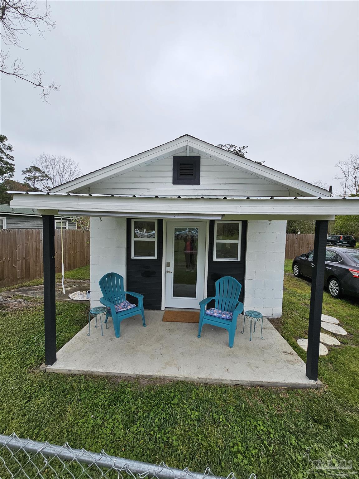 a front view of a house with sitting area and garden