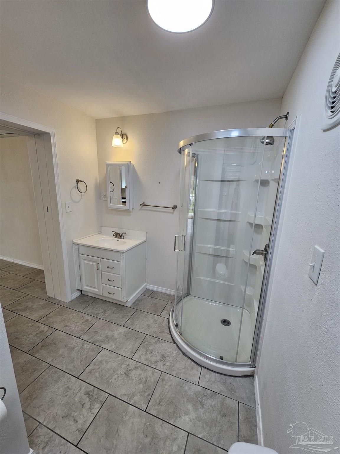 9775 North Loop Road, Unit 1 Pensacola, FL 32507 - Photo 11 of 12 a bathroom with a sink a toilet and shower