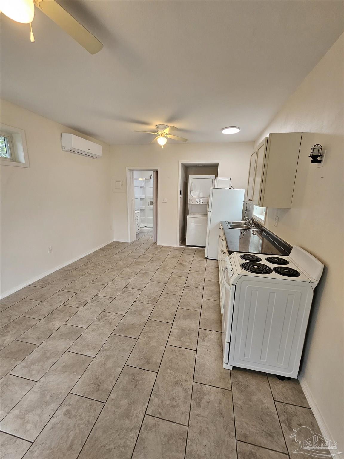 9775 North Loop Road, Unit 1 Pensacola, FL 32507 - Photo 7 of 12 a kitchen with stainless steel appliances granite countertop a stove a sink and a refrigerator