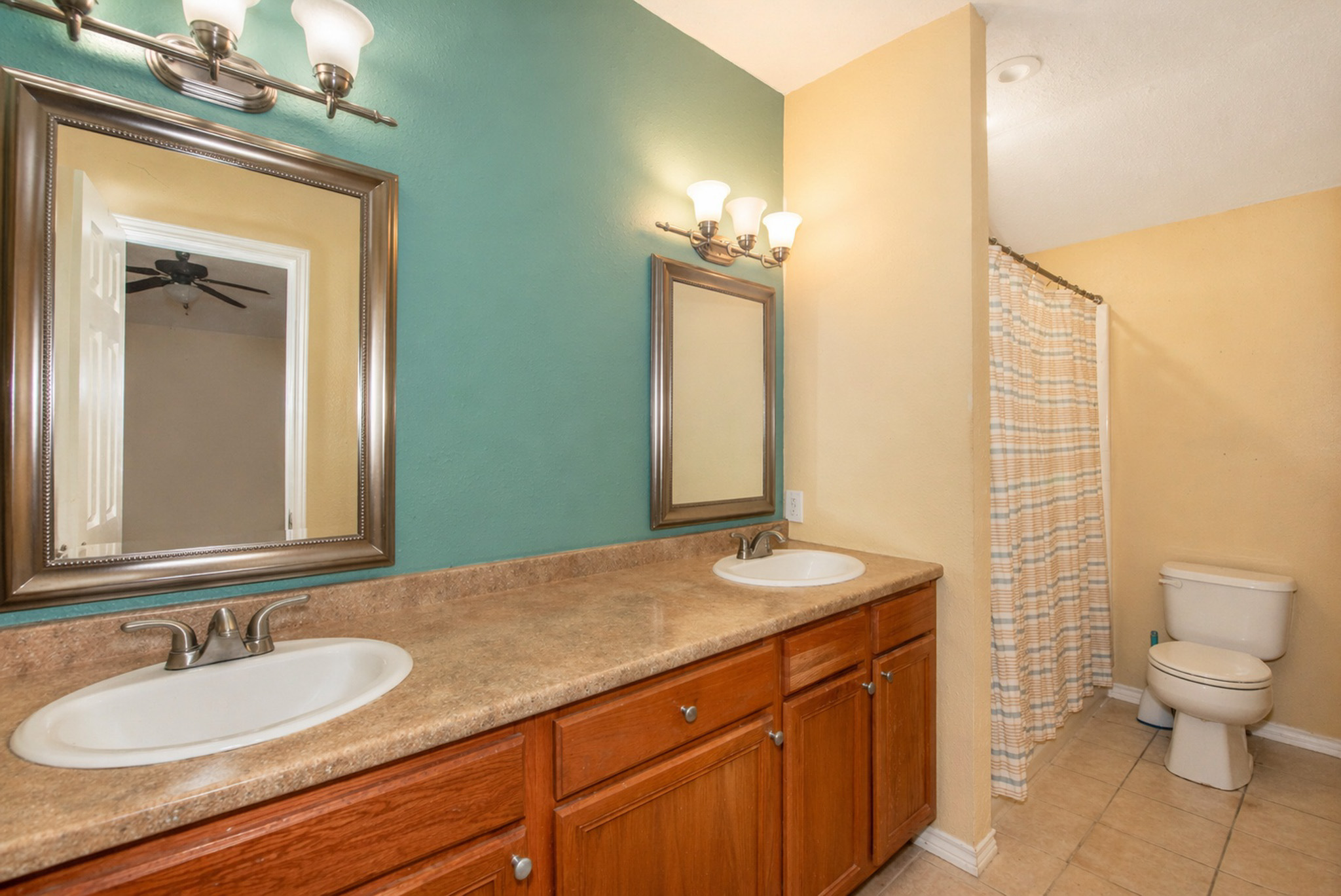 877 Hollow Bend Road, Unit 229 Caldwell, TX 77836 - Photo 8 of 18 a bathroom with a granite countertop sink a toilet and a mirror