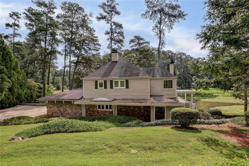 a aerial view of a house next to a big yard and large trees