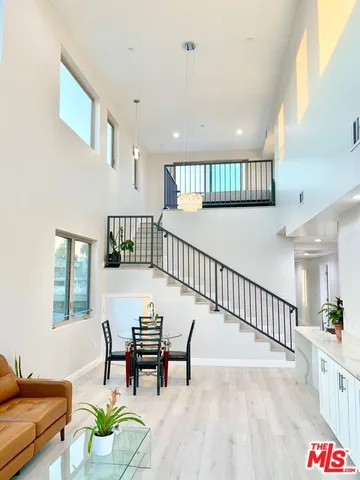 a view of dining room with furniture wooden floor and windows