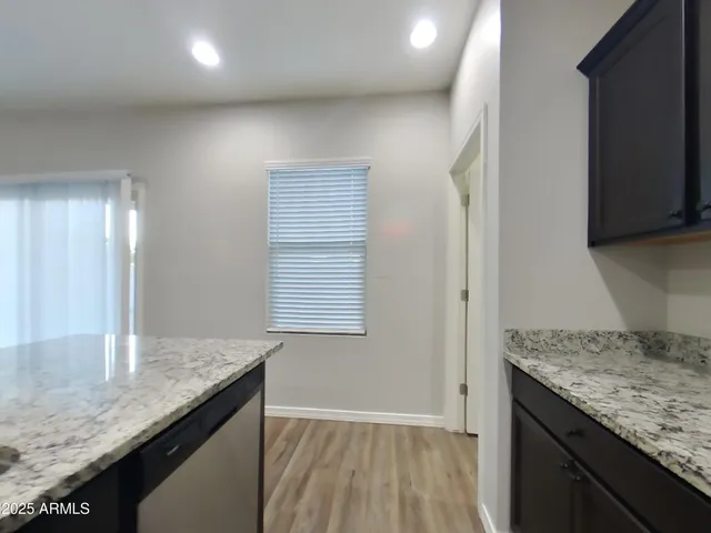 a kitchen with granite countertop sink and cabinets
