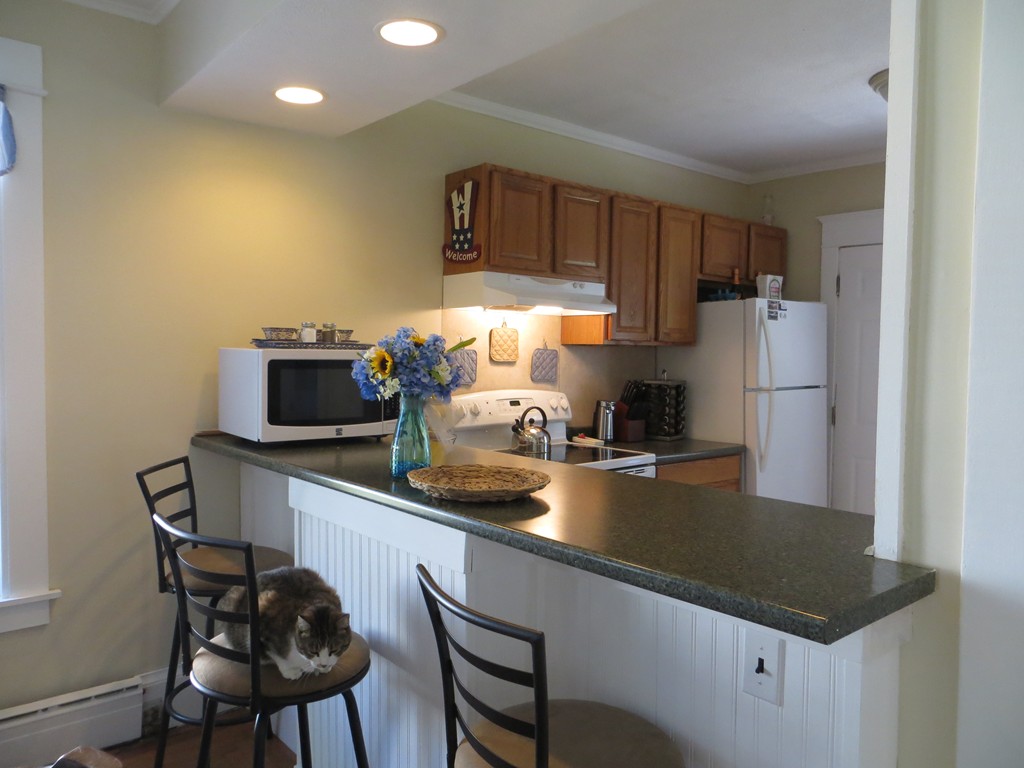 35 Ardmore Street Springfield, MA 01104 - Photo 7 of 19 a kitchen with stainless steel appliances a sink a stove a refrigerator cabinets and dining table