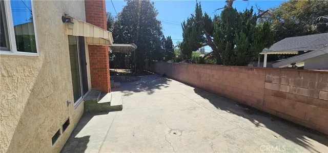 a backyard of a house with table and chairs
