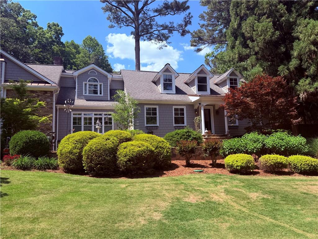5091 Miller Road Southwest Lilburn, GA 30047 - Photo 2 of 6 a front view of a house with garden