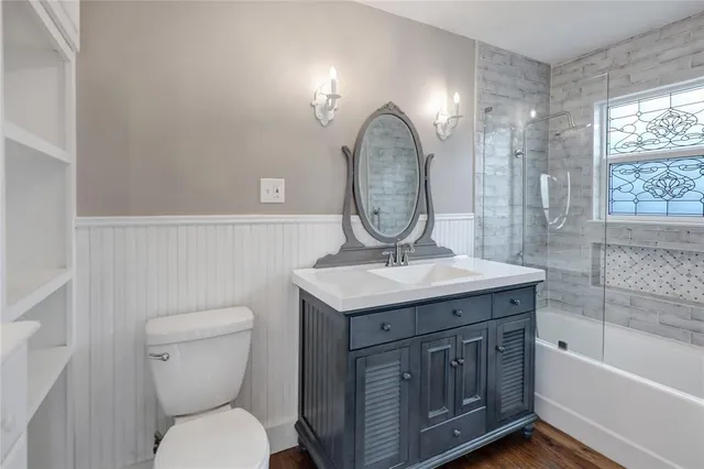 a bathroom with a granite countertop toilet a sink and bathtub