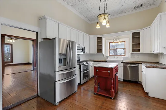 a kitchen with stainless steel appliances granite countertop a stove refrigerator and microwave