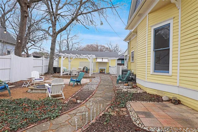 a view of a patio with table and chairs and potted plants