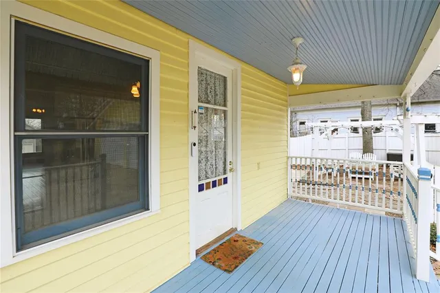 a view of a porch with wooden floor and furniture