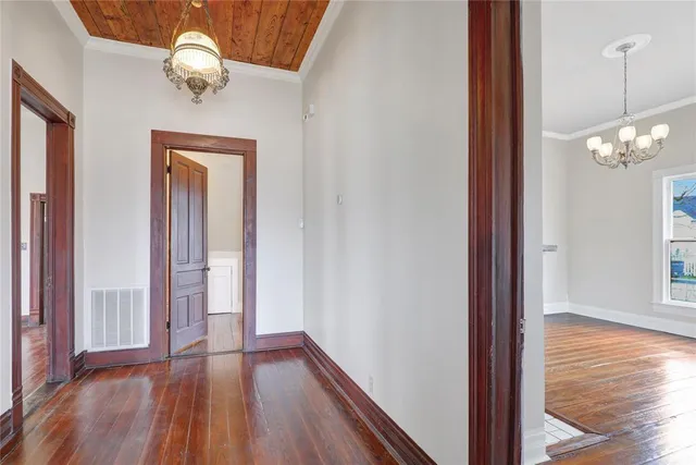 a view of a hallway with wooden floor and staircase
