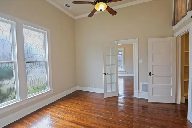 wooden floor in an empty room with a window