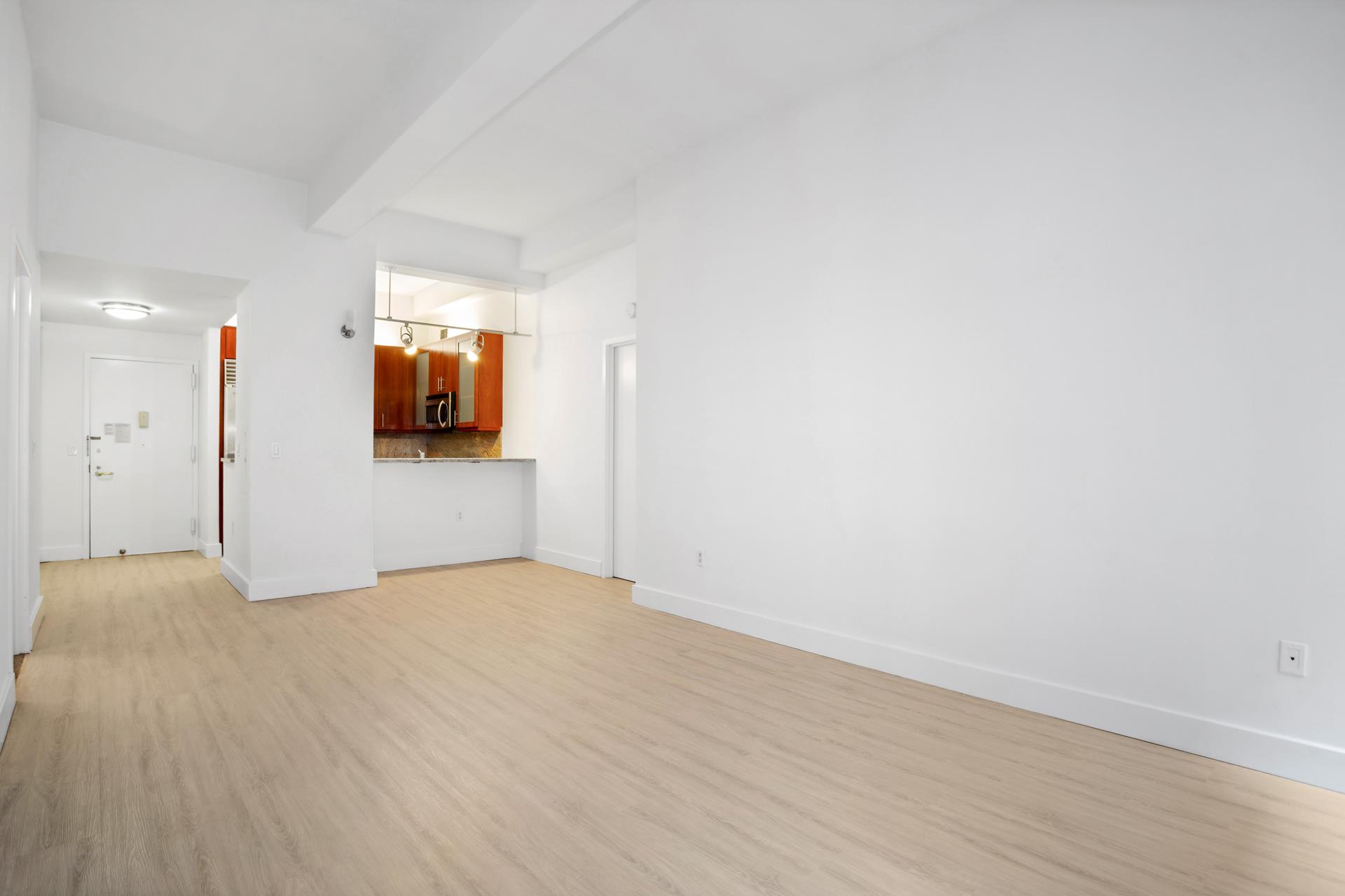 80 John Street, Unit 7G Manhattan, NY 10038 - Photo 6 of 9 a view of a livingroom with wooden floor