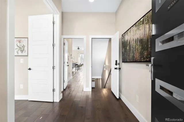 a view of a hallway with wooden floor