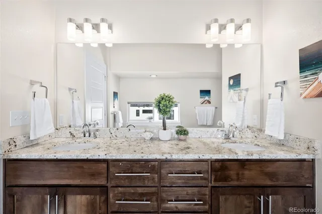 a bathroom with a sink double vanity and a mirror
