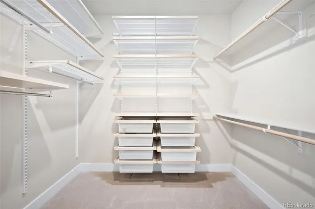 a view of walk in closet with empty racks