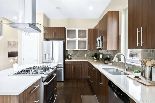 a kitchen with a sink stove top oven and cabinets