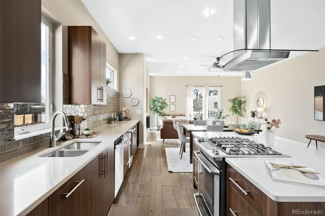 a kitchen with lots of counter top space a sink appliances and cabinets