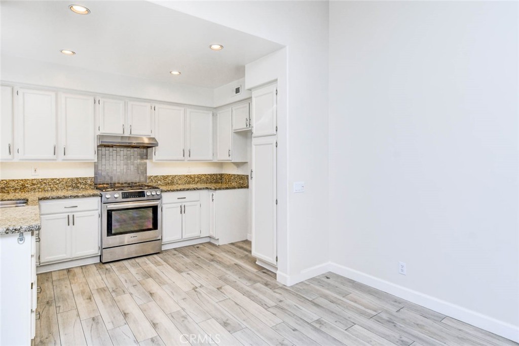 1 La Ronda Irvine, CA 92606 - Photo 11 of 29 a kitchen with a stove and white cabinets