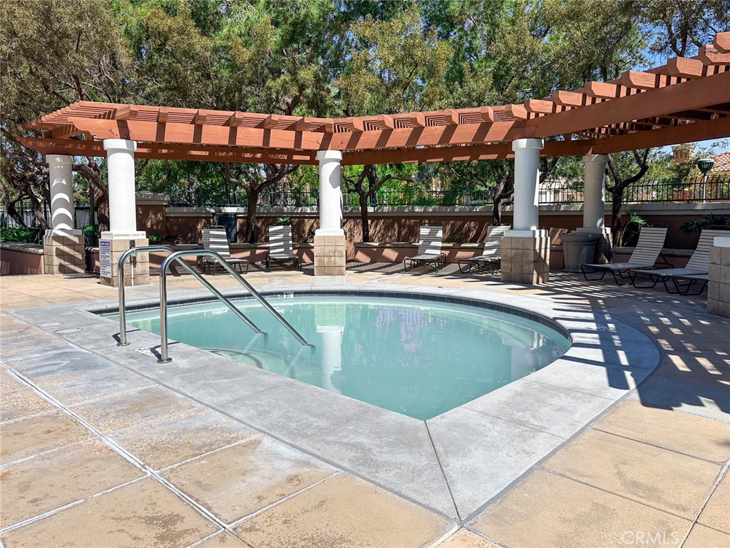 1 La Ronda Irvine, CA 92606 - Photo 27 of 29 a view of a patio with a table and chairs under an umbrella