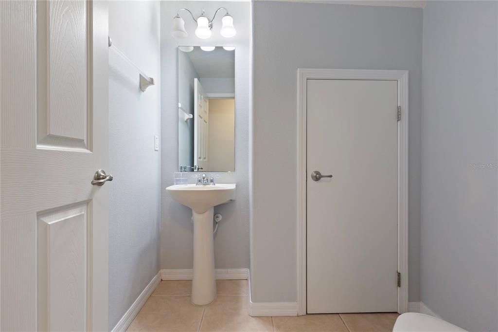 10901 Brickside Court Riverview, FL 33579 - Photo 14 of 36 a bathroom with a sink a mirror and a shower