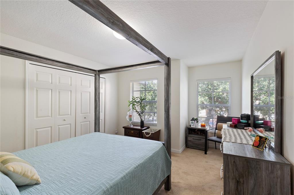 10901 Brickside Court Riverview, FL 33579 - Photo 16 of 36 a bedroom with a bed and large windows