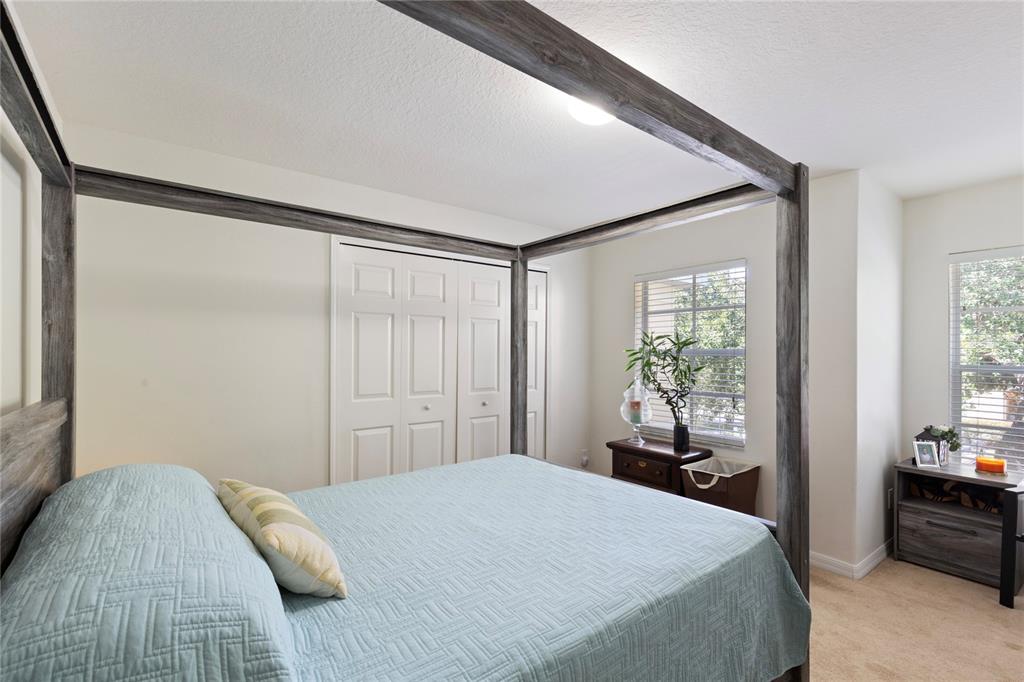 10901 Brickside Court Riverview, FL 33579 - Photo 17 of 36 a bedroom with a bed and a large window