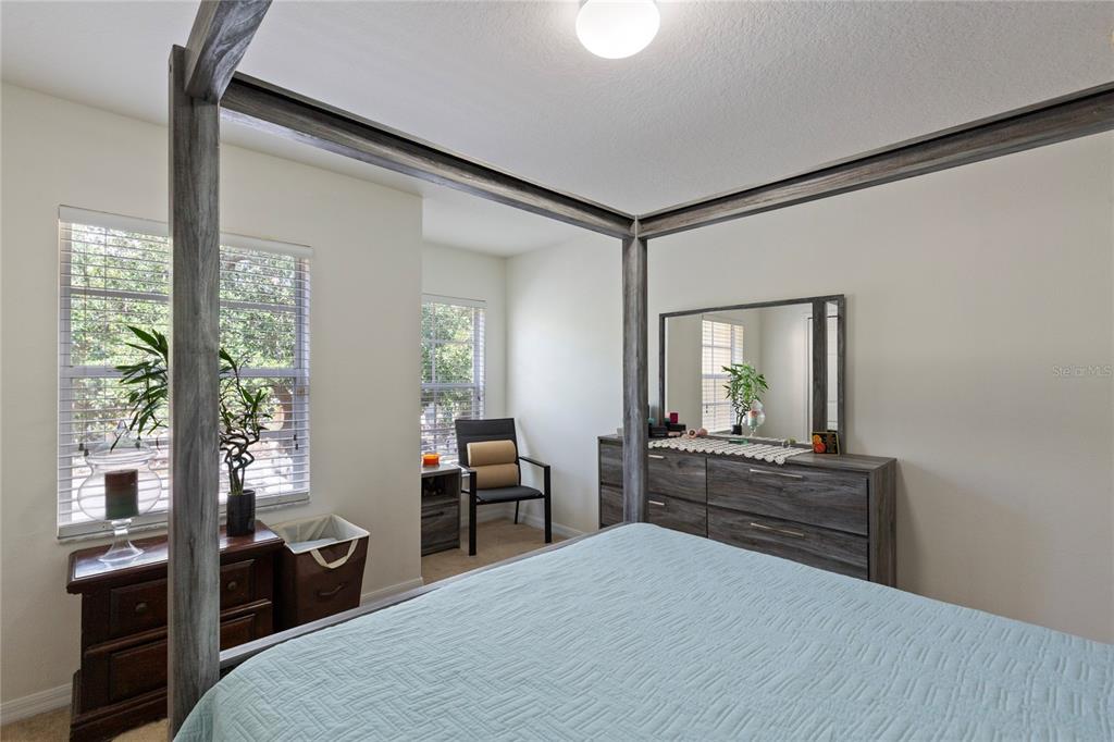 10901 Brickside Court Riverview, FL 33579 - Photo 18 of 36 a bedroom with a bed and wooden floor