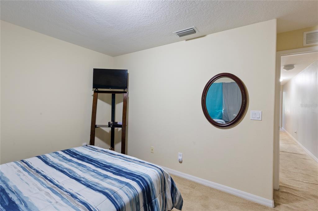 10901 Brickside Court Riverview, FL 33579 - Photo 22 of 36 a bedroom with a bed and a a table in it